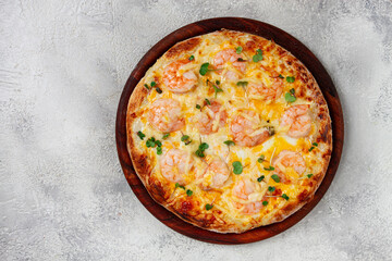 four cheese pizza with shrimp and fresh microgreens, served on a wooden board, homemade, no people,
