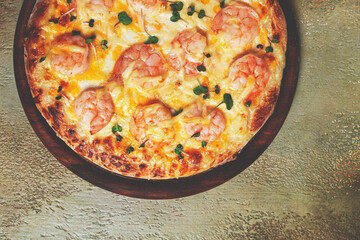 four cheese pizza with shrimp and fresh microgreens, served on a wooden board, homemade, no people,