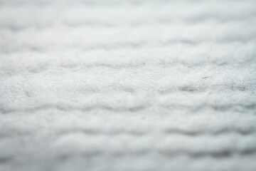 Fototapeta premium Extreme closeup of white handmade paper with shallow depth of field.
