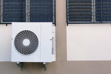 An air conditioner installed on the wall of a building,