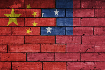 colourful painted big flag of china and flag of Samoa on a massive old brick wall background....