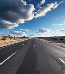 Naklejka premium A long stretch of asphalt road disappears into the distance under a brilliant blue sky with a few wispy clouds, landscape, blue