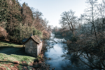 Old boathouse by lake in Winter