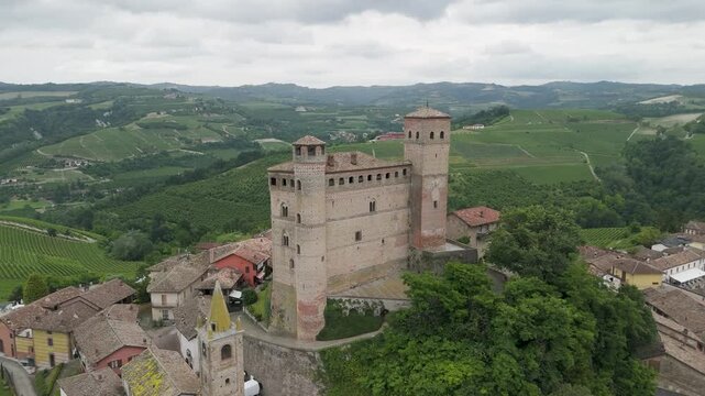 Serralunga d'Alba, Langhe region, Cuneo, Piedmont, Italy. 4k aerial view of the town and vineyards. Langhe-Roero and Monferrato. Circling to the left around the castle.
