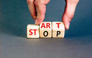 Start or stop symbol. Concept words Start or Stop on beautiful wooden block. Beautiful grey table...
