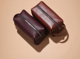 Leather cosmetic bags organizers on beige background
