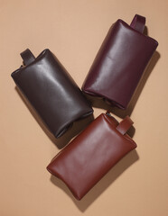 Leather cosmetic bags organizers on beige background