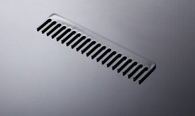 Plastic comb on black background close up