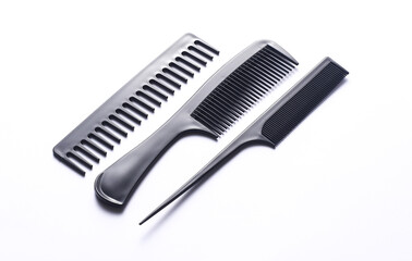 Set of black plastic combs on white background