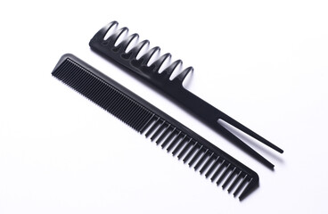 Set of black plastic combs on white background