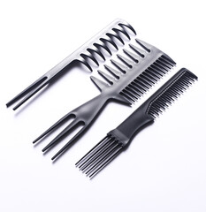 Set of black plastic combs on white background