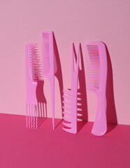 Plastic combs on pink background. Beauty concept. Creative layout. Minimalism