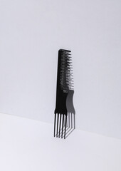 Plastic comb on gray background. Beauty concept. Creative layout. Minimalism