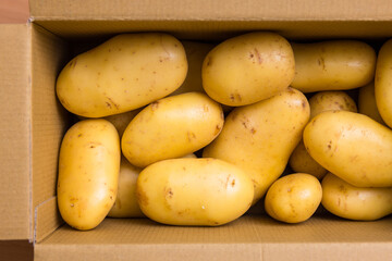 Pile of brown potatoes in storage box