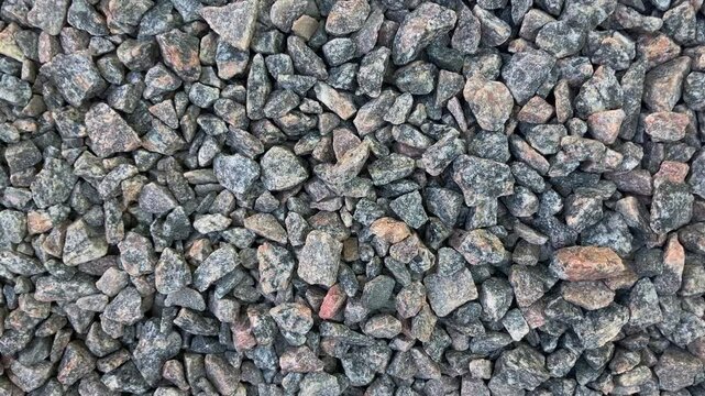Crushed granite background. Slow motion. Close up.