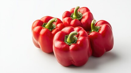 Fresh red bell peppers stacked on a white background with Copy Space for text placement