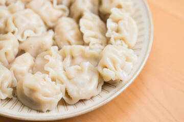 Cooked Chinese meat dumplings on white plate