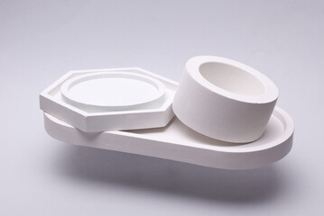 White Plaster Trays Floating on Gray Background