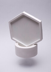 White Plaster Trays Floating on Gray Background