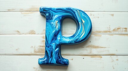 Blue and white marbled letter P displayed on a wooden surface with textures and Copy Space for text placement