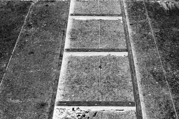 A wooden frame on a construction site in black and white film negative.