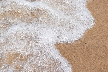 foam on the sandy beach