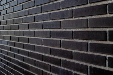 Black brick wall. Concept: Building, architecture, pattern, black brick.