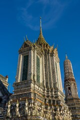 Exploring the intricate architecture of Wat Arun during a clear day in Thailand