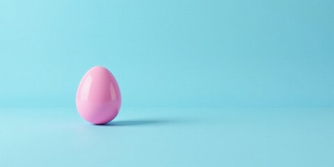 Fototapeta premium A Single Pink Egg on a Light Blue Background, Minimalist Springtime Design Concept