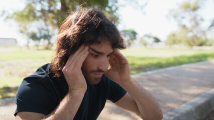 Pensive Long Hair Man Sitting On The Sidewalk Reflecting On Debts