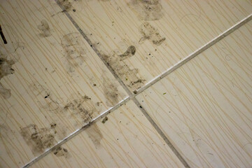 Dirty floor tiles showing stains and marks, illustrating the need for cleaning or maintenance