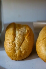 Freshly baked bread loaves on a kitchen counter, showcasing their golden crust and soft texture. Perfect for food lovers and culinary enthusiasts.