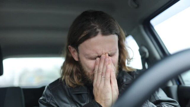 male driver worries and regrets disappointed while driving a car