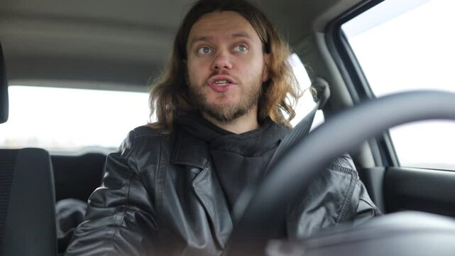 an emotional man driving a car