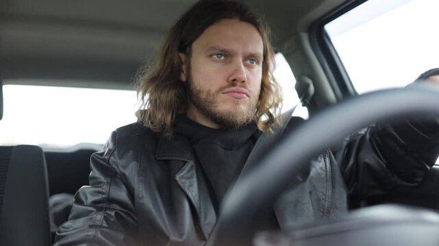 an emotional man driving a car