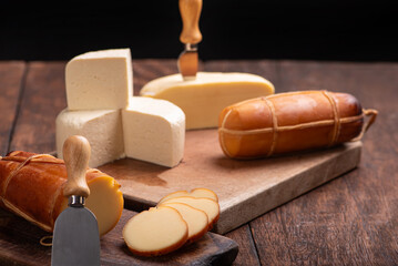 Table with cheeses, delicious cheeses from Brazil on a rustic wooden table, selective focus.