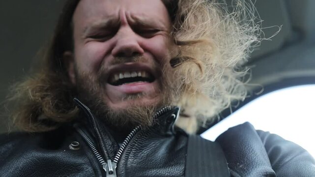 male driver worries and regrets disappointed while driving a car