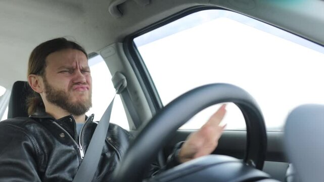 an emotional man driving a car