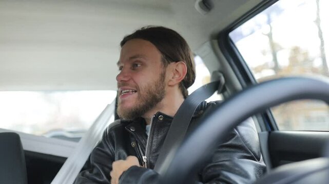 an emotional man driving a car