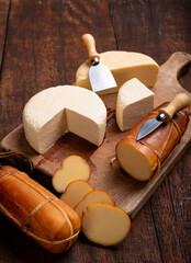 Table with cheeses, delicious cheeses from Brazil on a rustic wooden table, selective focus.
