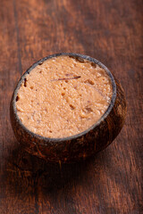 Coconut candy (cocada), Delicious cocada made in Brazil and presented inside the coconut shell, selective focus.