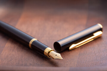 Fountain pen, beautiful fountain pen in detail on wooden surface, selective focus.