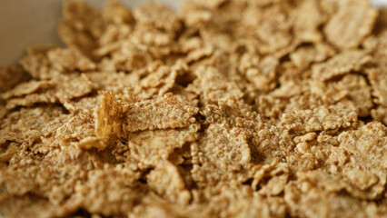 Closeup view of crispy corn flakes, perfect for breakfast, highlighting the texture and golden color of the cereal