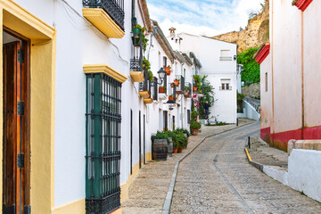 Fototapeta premium A picturesque, colorful traditional street in the White Village of Zahara de la Sierra in the Andalusian region of Southern, Spain. 