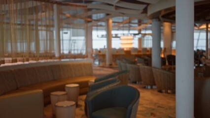 Blurry luxury restaurant interior with elegant seating and ambient lighting creating a comfortable atmosphere indoors for a sophisticated dining experience.