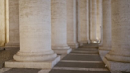 Columns in the vatican city captured in a defocused, blurred image highlighting the classic architectural details and serene ambiance of italy's famous landmark.