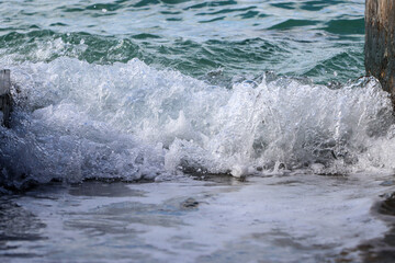 Sea wave rolling on the coast rocks
