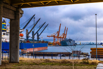 Gdynia, Poland - December 31. 2024 Port of Gdynia, port cranes, cargo ships, containers, work in...