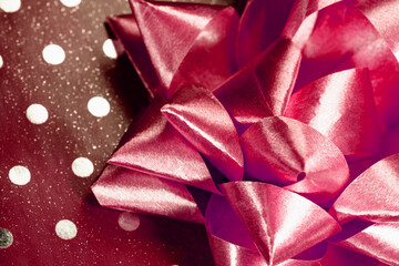 Red silk bow on gift box close up