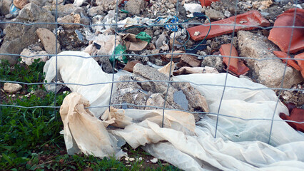 Waste from construction work close-up, illegal dumping of garbage in nature, environmental...